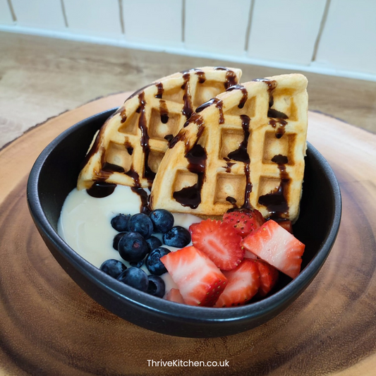 Homemade Belgian waffles with chocolate sauce, yogurt and fresh berries